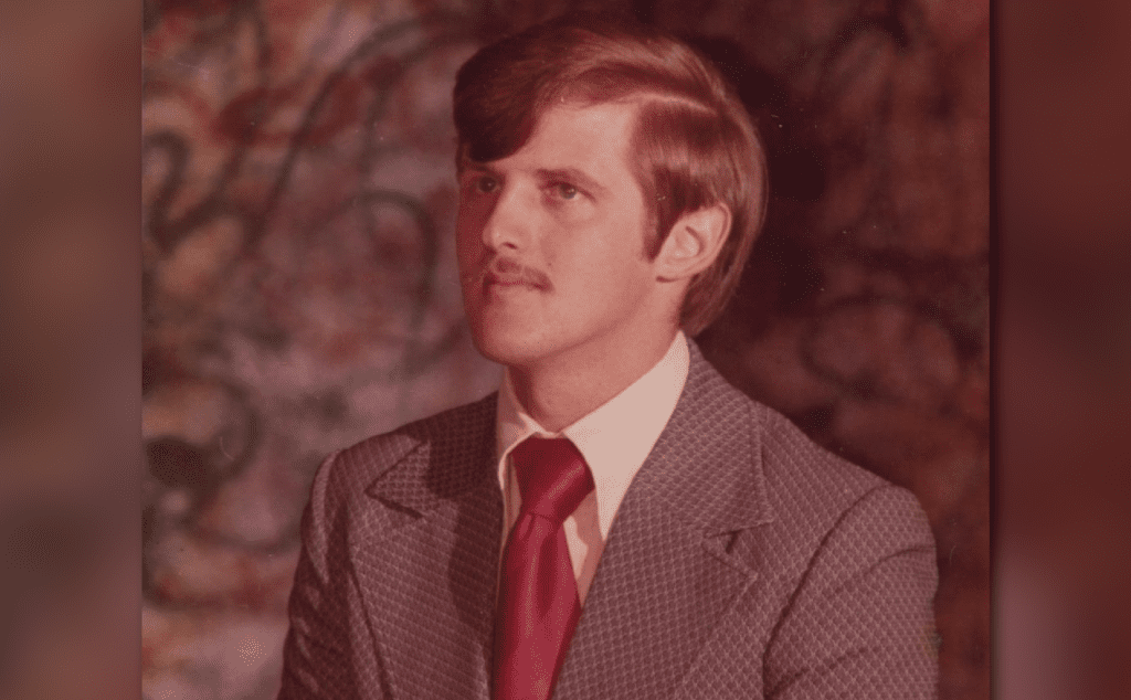 An old photo of a man in a suit and tie.