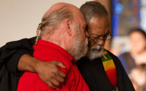 Two men hugging each other in a church.