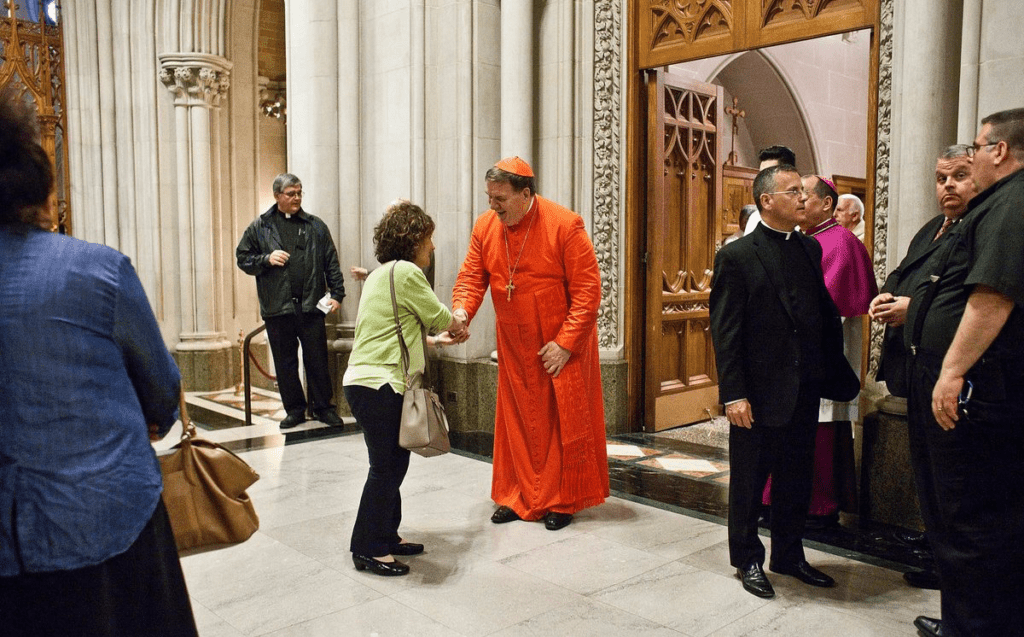 A group of people standing in a church.