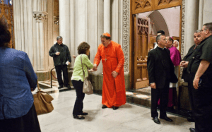 A group of people standing in a church.