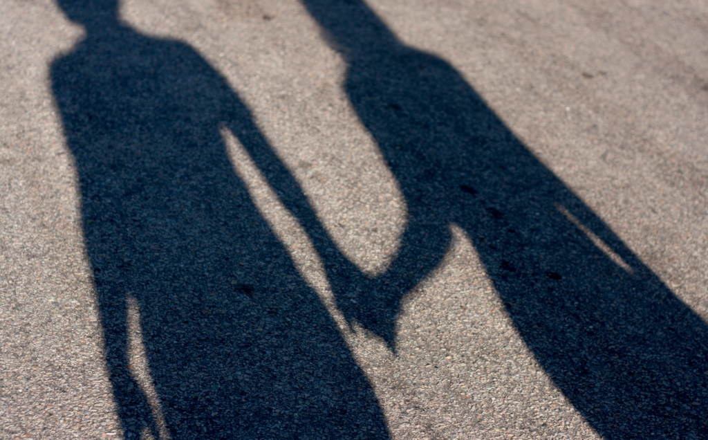 A Shadow Of Two People holding Hands