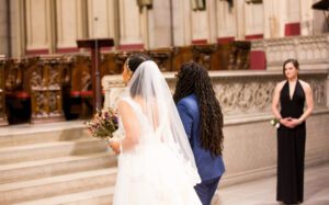 A bride walks down the aisle in a church.