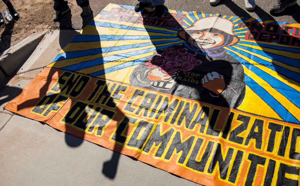 A group of people standing in front of a banner.