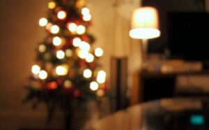 A blurry image of a christmas tree in a living room.