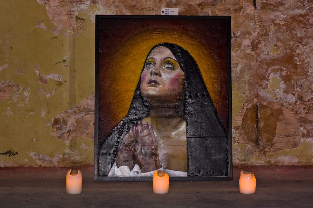 A painting of a woman with candles in front of her.