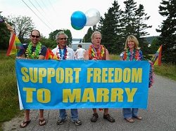A group of people holding a banner that says support freedom to marry.