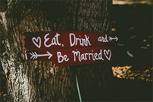 Eat drink be married sign on a tree.
