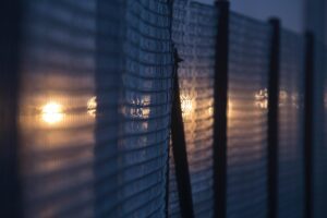 A close up of a fence with lights on it.