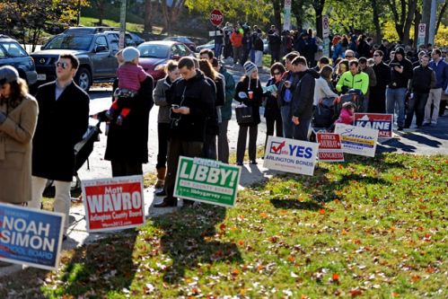 A group of people standing in a line with signs.