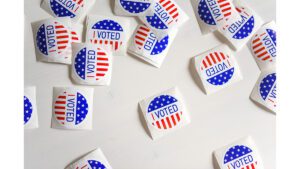 A group of voting stickers on a white surface.