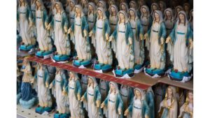 A row of statues of the virgin mary.
