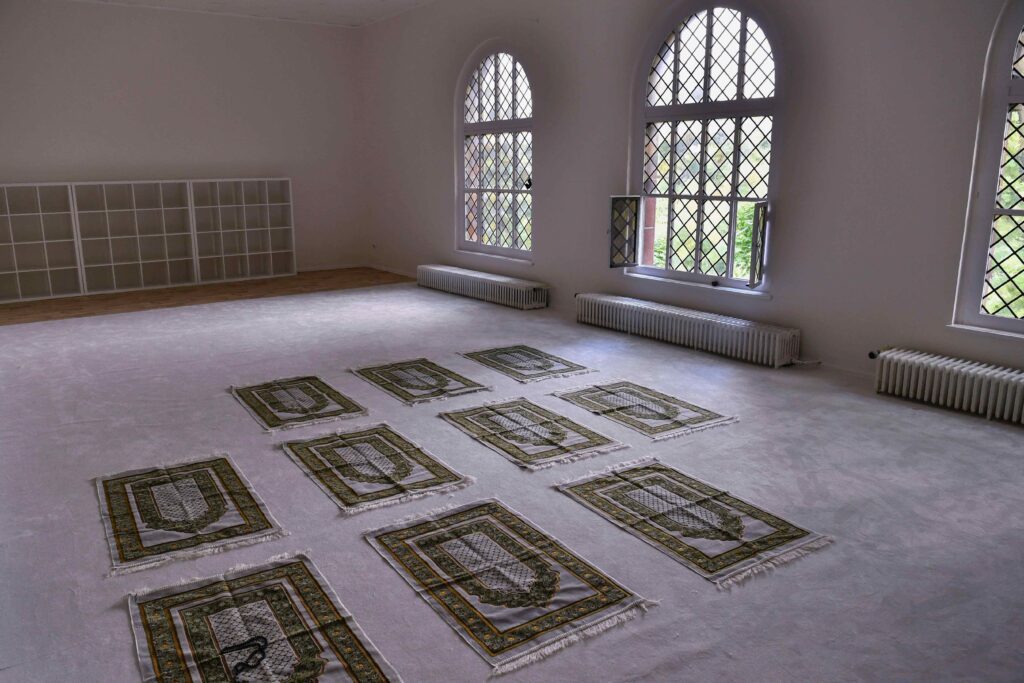 A room with several rugs on the floor.