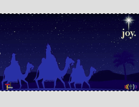 A christmas card with three camels and the word joy.