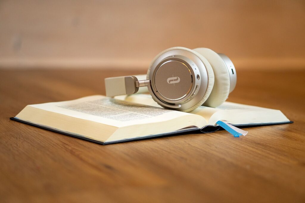 A pair of headphones sitting on top of an open book.