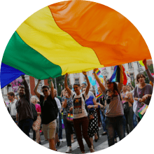 People raising the LGBTQIA+ flag